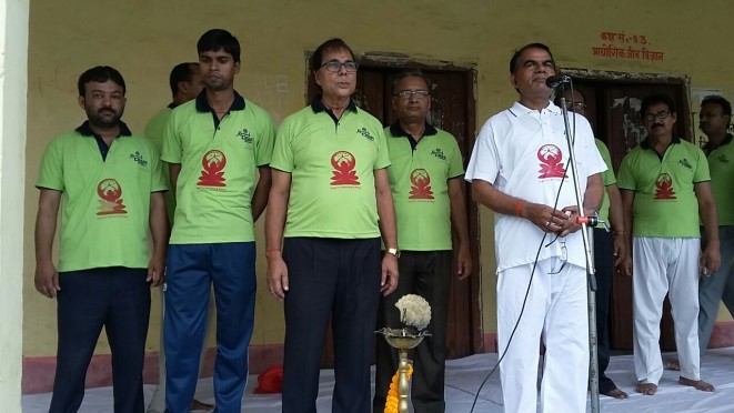 Samajsevi Dr.Bhupendra Narayan Yadav Madhepuri wearing green t-shirt, Dr. Niranjan Kumar and others doing yoga on International Yoga Day at S.N.P.M High School Madhepura