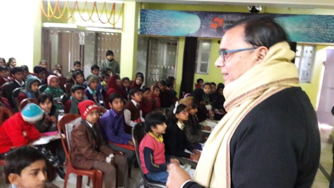 Dr.Bhupendra Madhepuri attending the kids in the final exam of Hindi Spelling Bee Championship 2016 at Samidha Group Hall Madhepura.