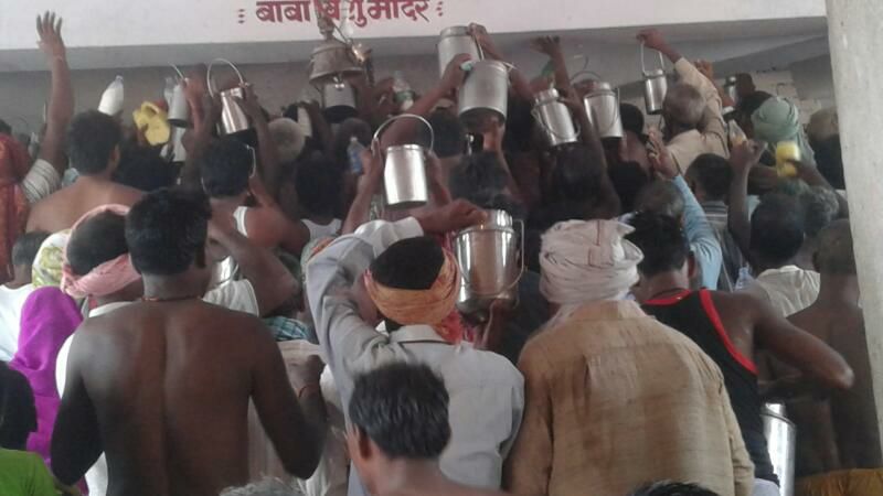 Devotees offering Raw Milk at Baba Vishuraut Temple.