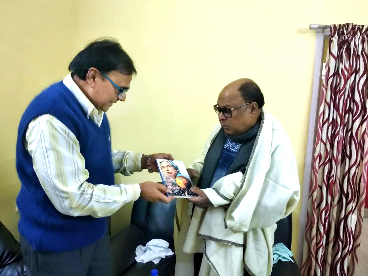 Dr.Bhupendra Madhepuri presenting his book "Chhota Lakshya Ek Apradh Hai" to Md.Aziz.