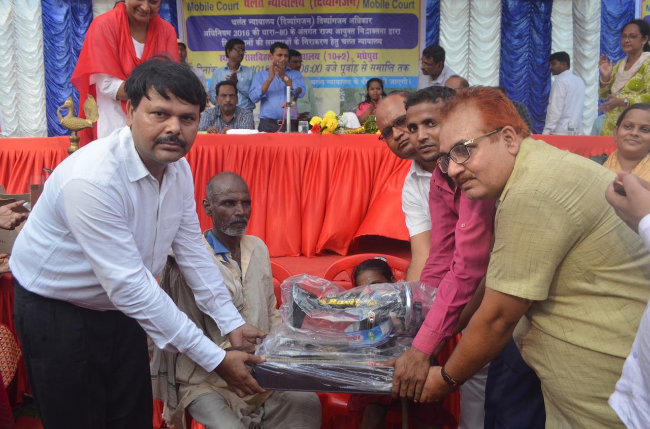 State Disability Commissioner Dr.Shivajee Kumar, Lead Bank Officer Ranjan Kumar Jha (Donor) & others giving a Hand Sewing Portable Machine to a disable girl under eighteen years.