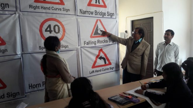 Samajsevi Dr.Bhupendra Madhepuri demonstrating rules of traffic rules on the occasion of Sadak Suraksha Maah at Samaharnalaya Madhepura.